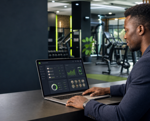 Kenyan gym owner reviewing a gym management system dashboard