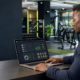 Kenyan gym owner reviewing a gym management system dashboard
